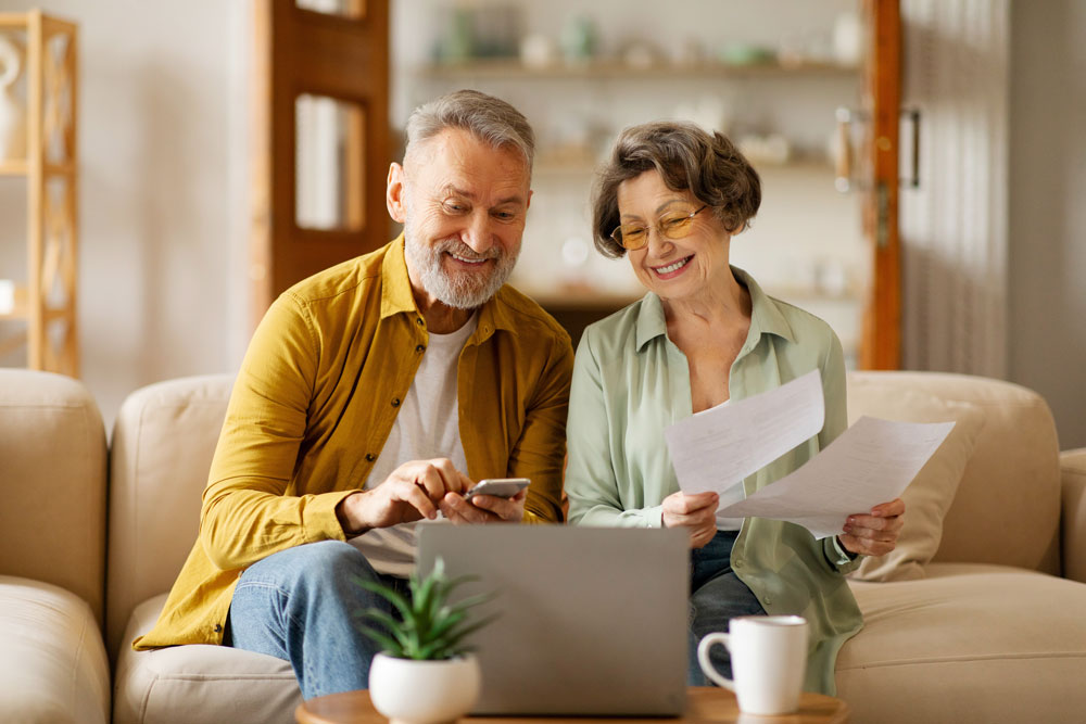 Homeowners reviewing documents for surplus funds recovery services